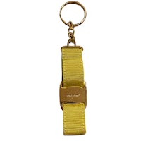 a yellow key chain on a white background