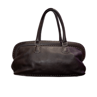 a brown leather bag with studding on it