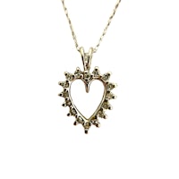 a heart shaped pendant with diamonds on a chain