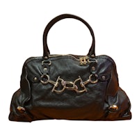 an image of a black handbag with metal handles