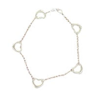 a bracelet with four hearts on a white background