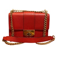 a red leather shoulder bag with a gold chain