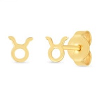 a pair of zodiac sign stud earrings in yellow gold