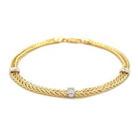 a yellow gold chain bracelet with diamonds