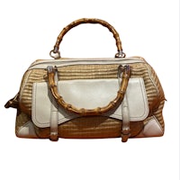 a beige and white handbag with a wooden handle