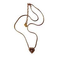 a gold necklace with a heart shaped pendant